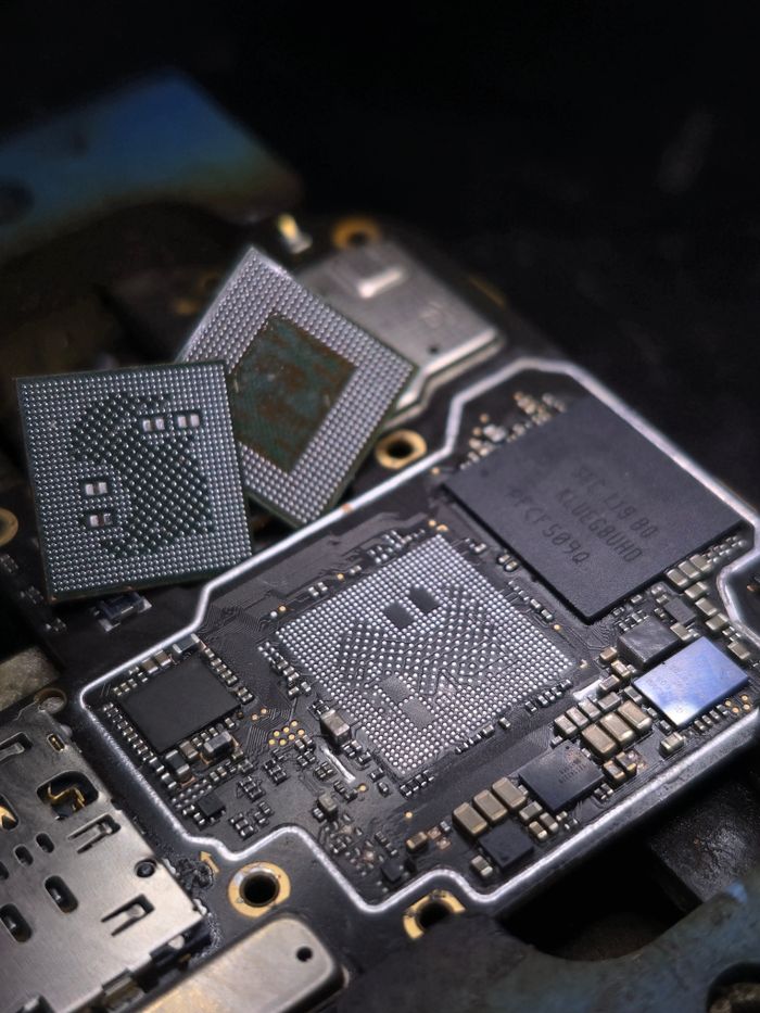 Detailed close-up of electronic microchips on a circuit board showcases technology architecture.